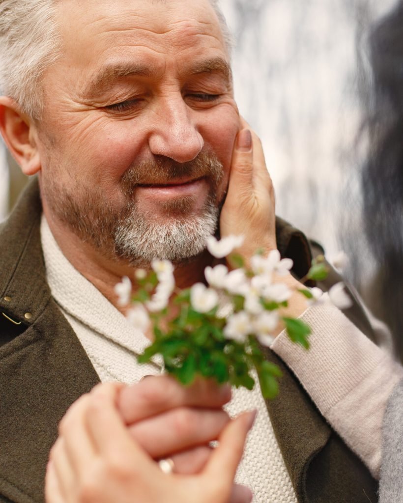 Seniors in a forest. People walks. Family with spring's flowers.
